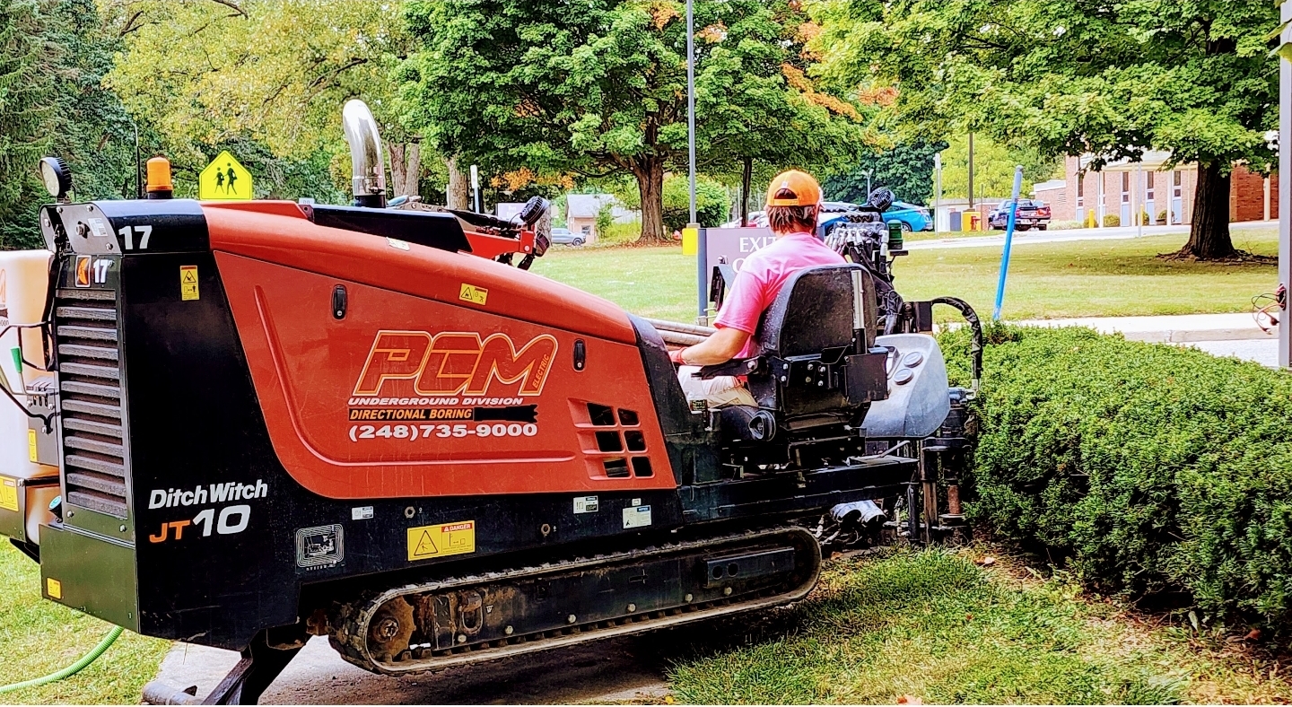 Directional boring machine installing underground utilities in a Michigan field
